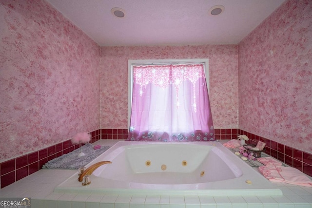 bathroom with plenty of natural light and tiled tub