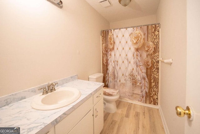 bathroom with vanity, hardwood / wood-style flooring, toilet, and curtained shower