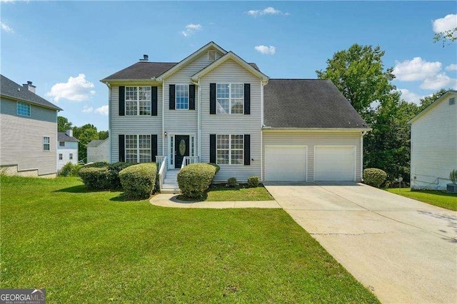 colonial inspired home featuring a garage and a front yard