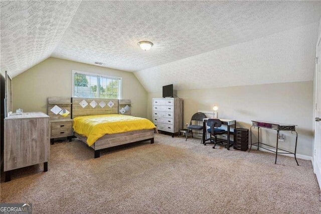 bedroom featuring carpet flooring, a textured ceiling, and vaulted ceiling