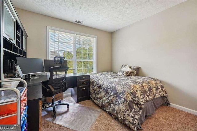 bedroom with carpet flooring and a textured ceiling