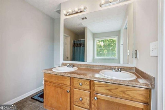 bathroom with tile patterned flooring and vanity