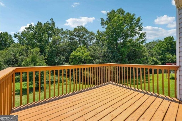 wooden deck with a lawn