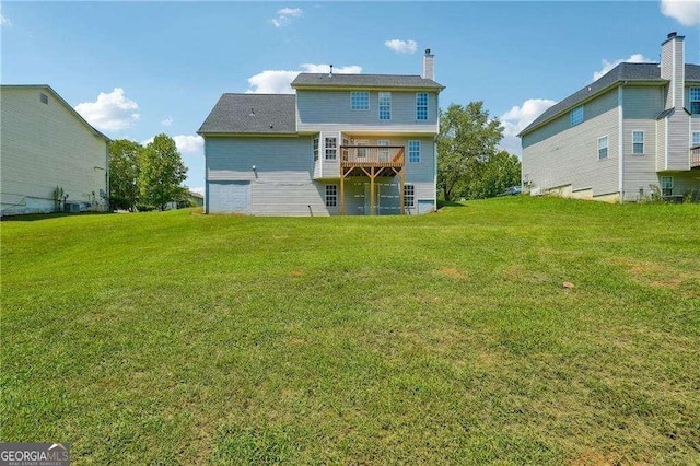 back of house with a wooden deck and a lawn