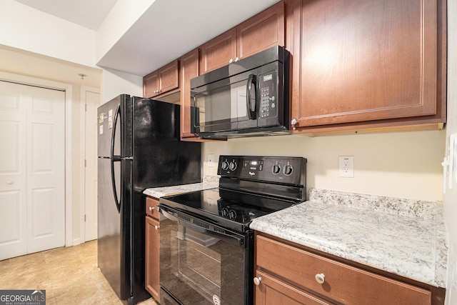 257 Country Club Dr, Jonesboro, GA 30238 - kitchen with black appliances, brown cabinets, and light stone counters