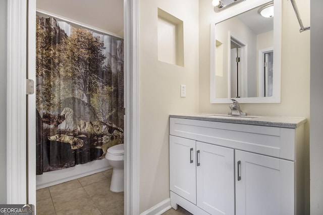 bathroom with tile patterned flooring, vanity, and toilet