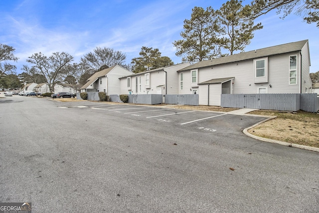 257 Country Club Dr, Jonesboro, GA 30238 - uncovered parking lot featuring a residential view and fence