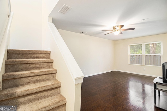 257 Country Club Dr, Jonesboro, GA 30238 - stairway featuring a ceiling fan, wood finished floors, baseboards, and a wood stove
