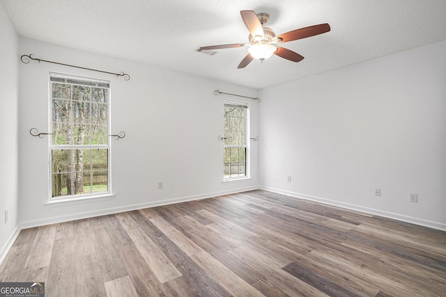 unfurnished room featuring ceiling fan, a textured ceiling, and hardwood / wood-style flooring