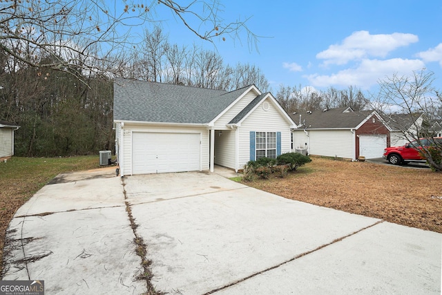 ranch-style home with a garage and cooling unit