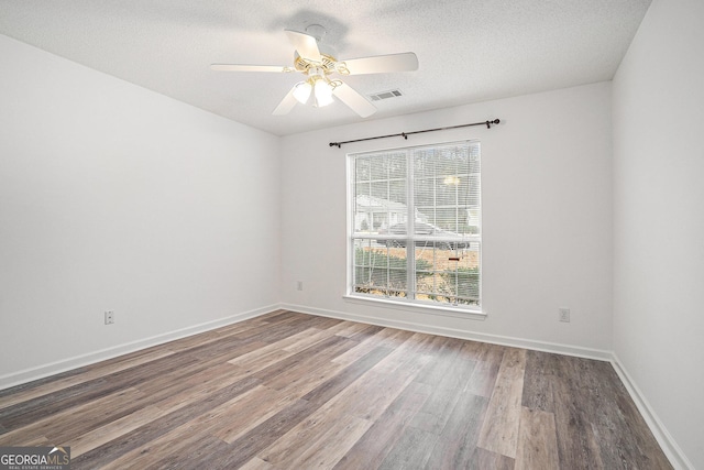 spare room featuring ceiling fan, a textured ceiling, and hardwood / wood-style flooring