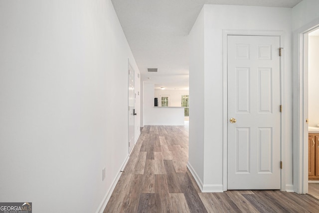 hallway featuring dark hardwood / wood-style flooring