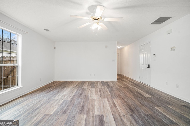 spare room with ceiling fan, hardwood / wood-style floors, and a textured ceiling