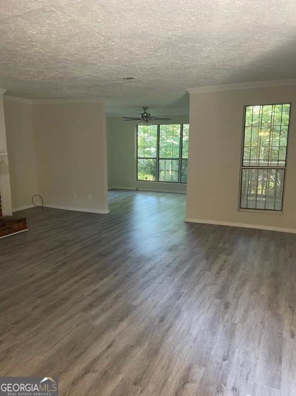 spare room with a textured ceiling, dark hardwood / wood-style floors, and ceiling fan