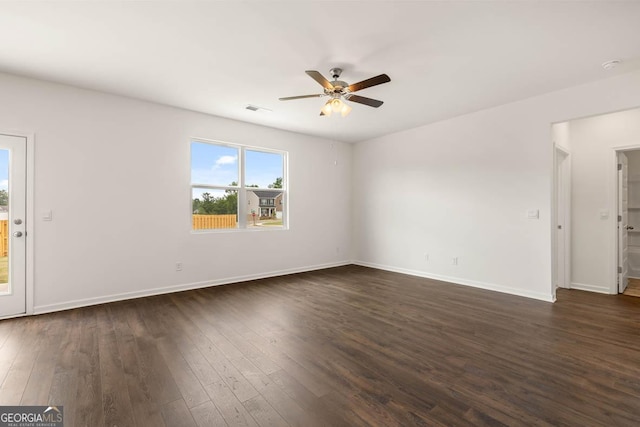 empty room with dark hardwood / wood-style floors and ceiling fan