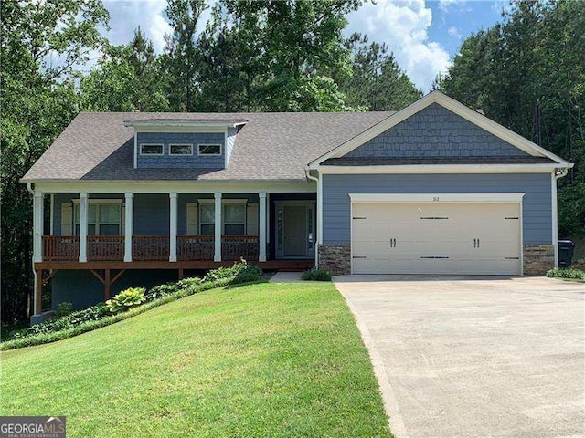 view of front of property with a front yard and a garage