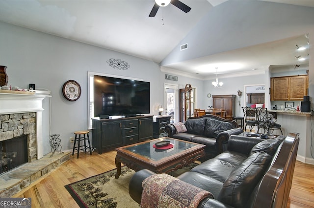 living room featuring light hardwood / wood-style flooring, crown molding, vaulted ceiling, a fireplace, and ceiling fan with notable chandelier