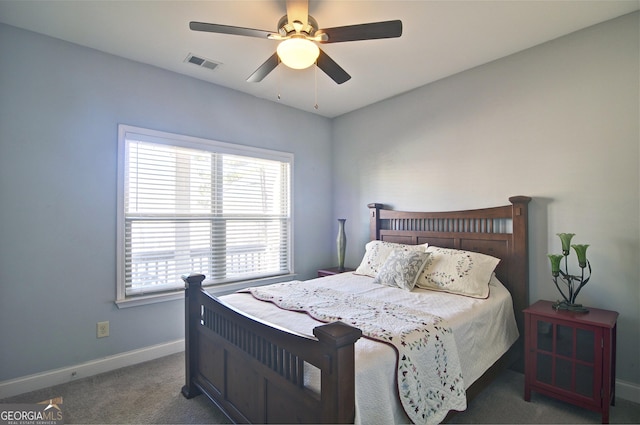 bedroom with ceiling fan and dark carpet