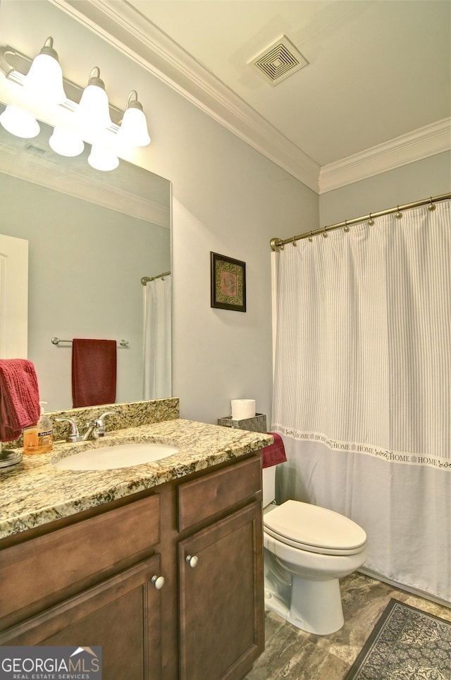 bathroom featuring toilet, vanity, and ornamental molding