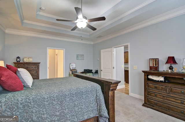 bedroom with ceiling fan, crown molding, light carpet, and a tray ceiling