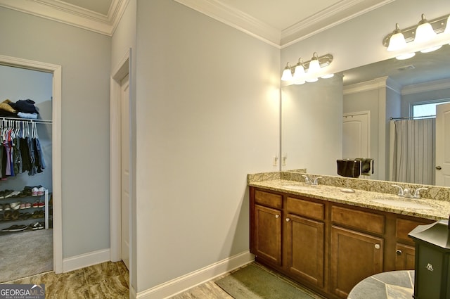 bathroom with vanity, walk in shower, and crown molding