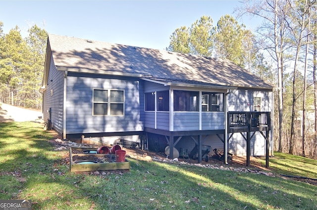 back of property with a lawn and a sunroom