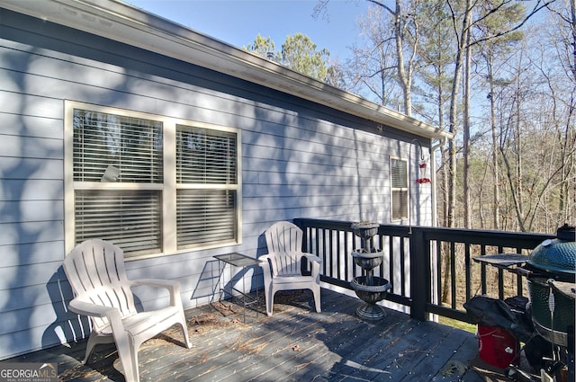 wooden terrace featuring a grill