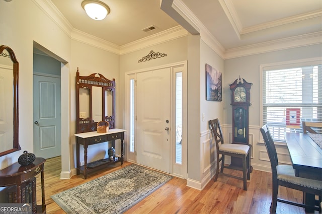 entrance foyer with light wood-type flooring and crown molding