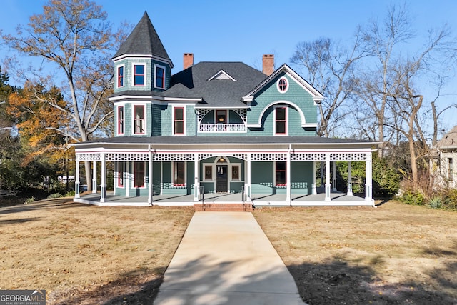 view of front of home with a porch and a front lawn