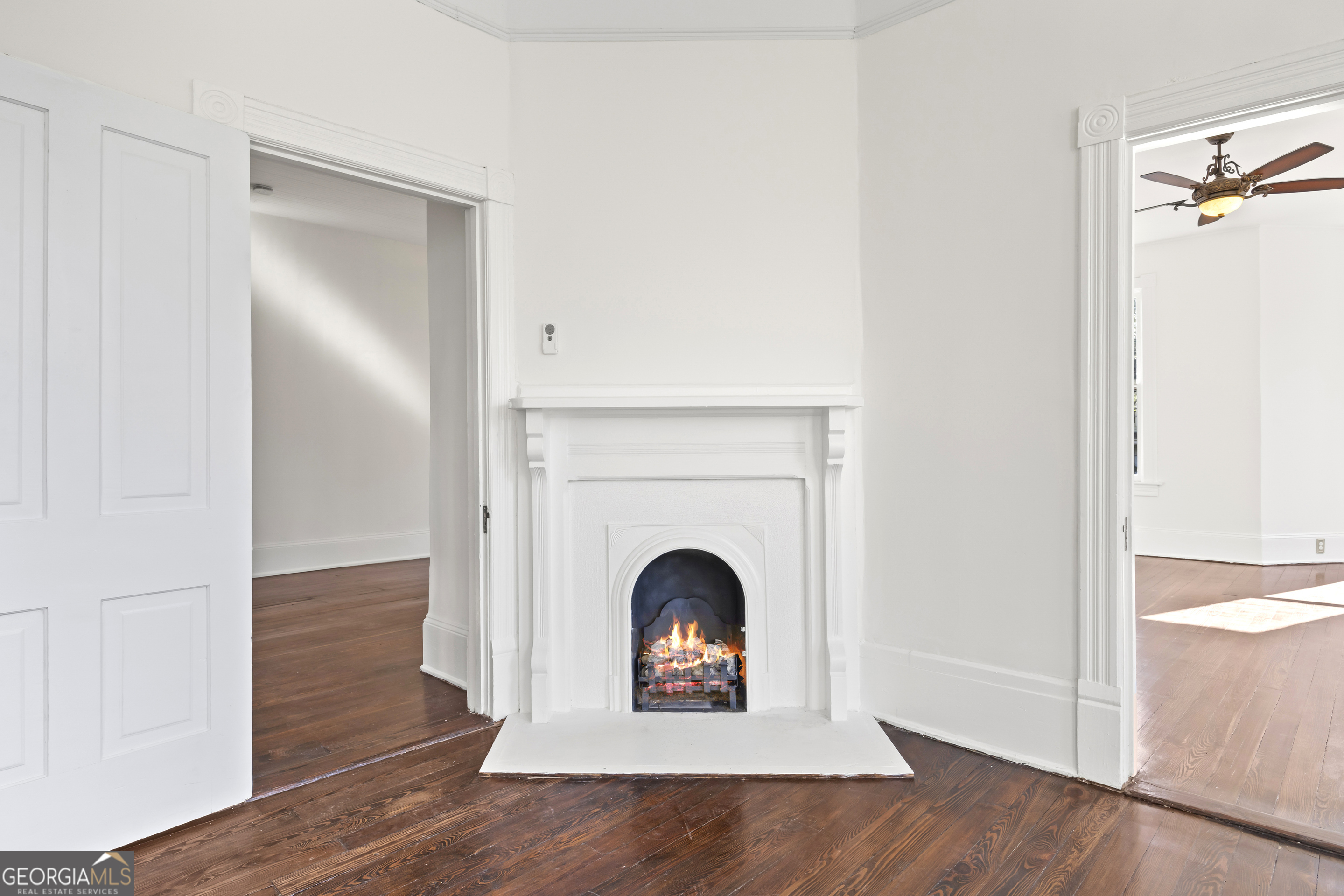 198 Dearing St, Athens, GA 30605 - unfurnished living room with baseboards, a ceiling fan, wood finished floors, and a lit fireplace
