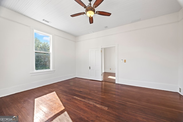 empty room featuring ceiling fan and dark hardwood / wood-style flooring