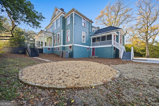 view of property exterior featuring a sunroom and central AC unit