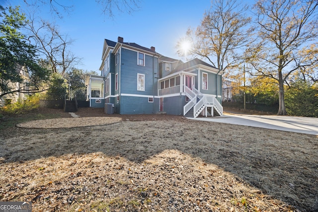 back of house with a sunroom and a patio