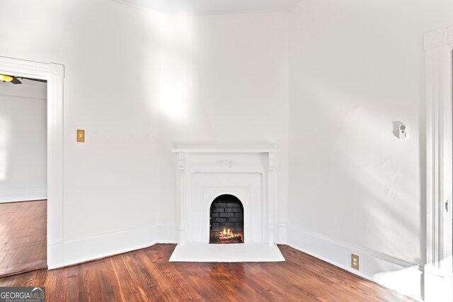 198 Dearing St, Athens, GA 30605 - unfurnished living room featuring wood finished floors, baseboards, and a lit fireplace