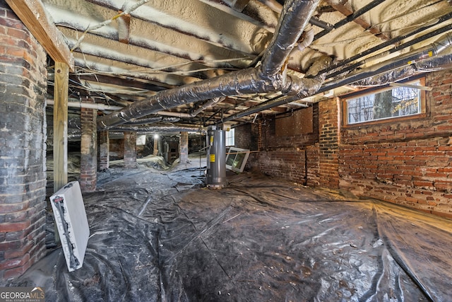 basement with brick wall and water heater