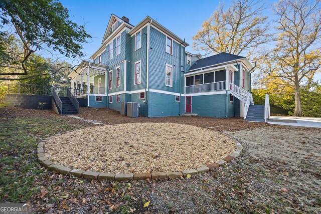 198 Dearing St, Athens, GA 30605 - rear view of house with cooling unit, a sunroom, a chimney, and stairway