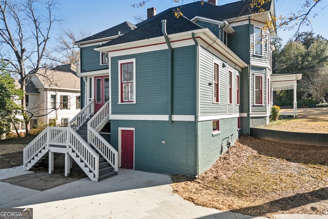 198 Dearing St, Athens, GA 30605 - view of front of home featuring brick siding, a chimney, and stairway