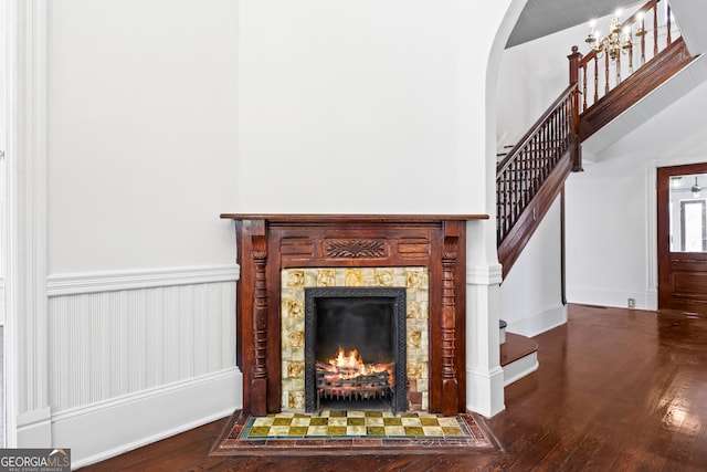 room details with a tile fireplace and wood-type flooring