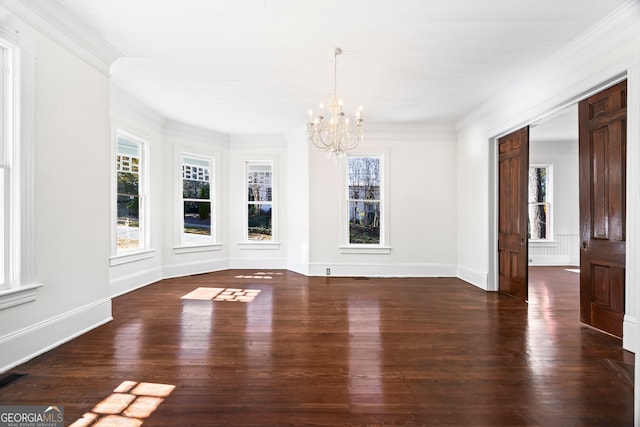 unfurnished dining area with dark hardwood / wood-style flooring, ornamental molding, and an inviting chandelier