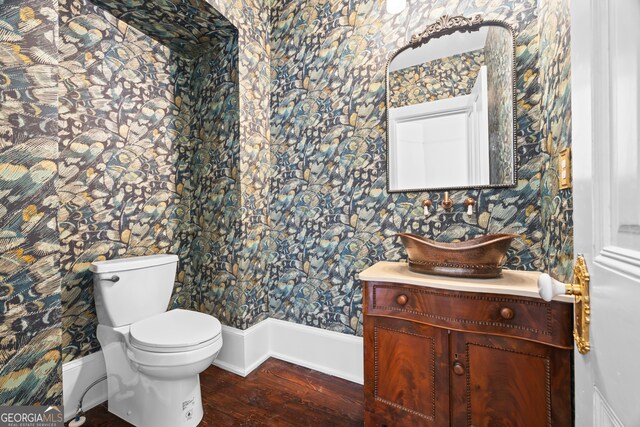 198 Dearing St, Athens, GA 30605 - bathroom with wood finished floors, wallpapered walls, vanity, baseboards, and toilet