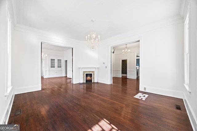 unfurnished living room with a chandelier, dark hardwood / wood-style floors, and crown molding