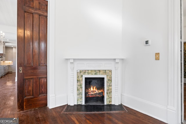 unfurnished living room with dark hardwood / wood-style floors and a tile fireplace