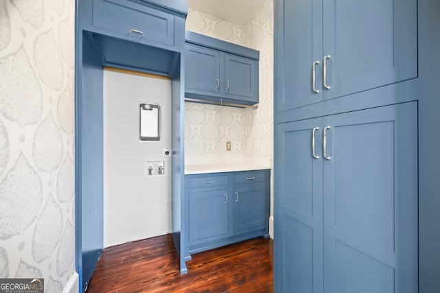 kitchen with dark hardwood / wood-style floors, blue cabinets, and backsplash