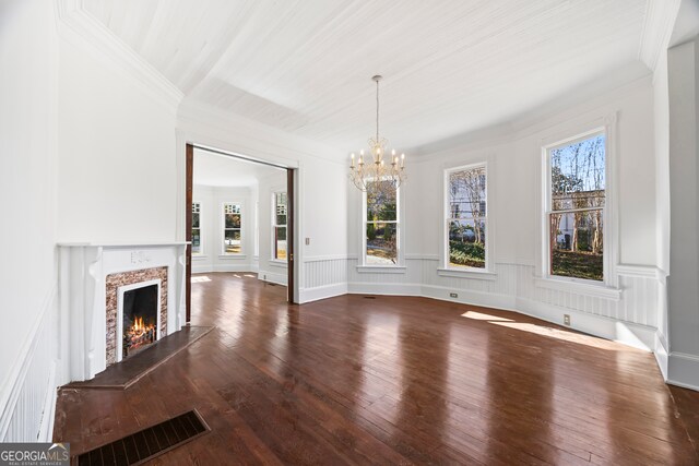 198 Dearing St, Athens, GA 30605 - unfurnished living room with a wainscoted wall, an inviting chandelier, a high end fireplace, wood finished floors, and visible vents