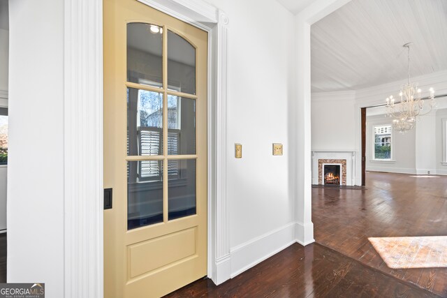 198 Dearing St, Athens, GA 30605 - entryway featuring an inviting chandelier, a brick fireplace, dark wood-style floors, and baseboards