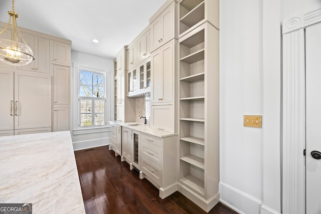 spacious closet featuring dark hardwood / wood-style flooring, sink, and wine cooler