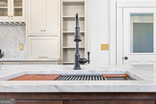 interior details featuring light stone counters and backsplash