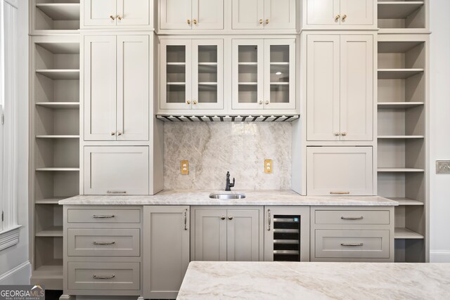 198 Dearing St, Athens, GA 30605 - bar featuring tasteful backsplash, beverage cooler, baseboards, and a sink