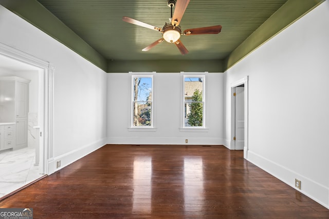 unfurnished room featuring ceiling fan and dark hardwood / wood-style flooring