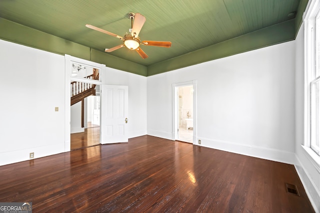 spare room with ceiling fan and dark wood-type flooring